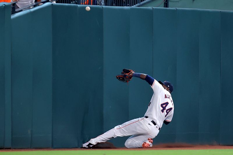 Jun 2, 2024; Houston, Texas, USA; Houston Astros left fielder Yordan Alvarez (44) slides into the retaining wall while attempting to catch a fly ball against the Minnesota Twins during the seventh inning at Minute Maid Park. Mandatory Credit: Erik Williams-USA TODAY Sports