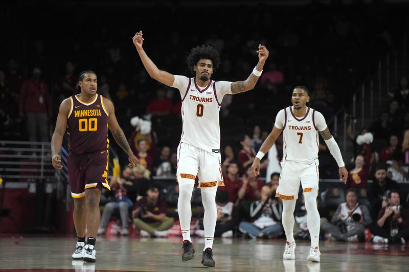 Feb 15, 2025; Los Angeles, California, USA; Southern California Trojans forward Saint Thomas (0) and guard Chibuzo Agbo (7) and Minnesota Golden Gophers forward Frank Mitchell (00 react in the second half at the Galen Center. Mandatory Credit: Kirby Lee-Imagn Images