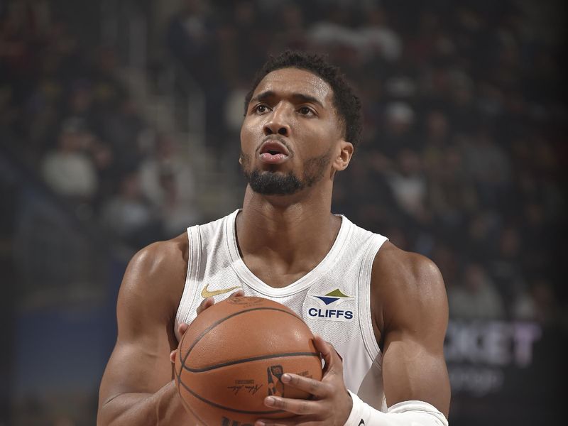 CLEVELAND, OH - JANUARY 27: Donovan Mitchell #45 of the Cleveland Cavaliers shoots a free throw during the game against the Detroit Pistons on January 27, 2025 at Rocket Mortgage FieldHouse in Cleveland, Ohio. NOTE TO USER: User expressly acknowledges and agrees that, by downloading and/or using this Photograph, user is consenting to the terms and conditions of the Getty Images License Agreement. Mandatory Copyright Notice: Copyright 2025 NBAE (Photo by David Liam Kyle/NBAE via Getty Images)