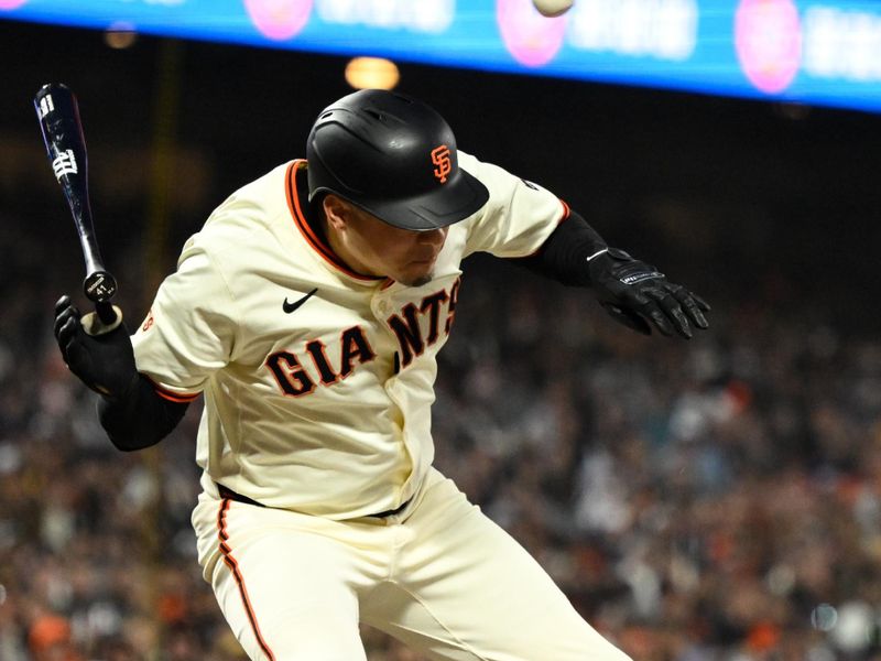 Jun 4, 2025; San Francisco, California, USA; San Francisco Giants first baseman Wilmer Flores (41) dodges a pitch from the San Diego Padres in the seventh inning at Oracle Park. Mandatory Credit: Eakin Howard-Imagn Images