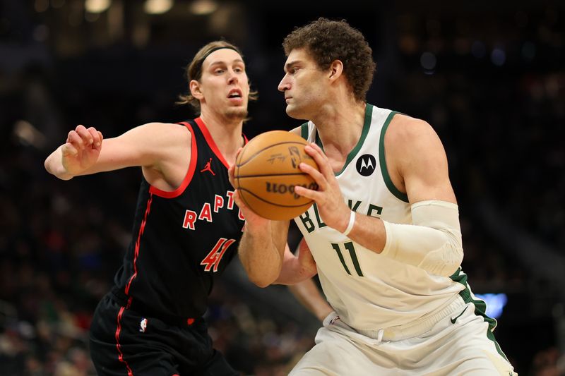 MILWAUKEE, WISCONSIN - APRIL 05: Brook Lopez #11 of the Milwaukee Bucks is defended by Kelly Olynyk #41 of the Toronto Raptors during the second half of a game at Fiserv Forum on April 05, 2024 in Milwaukee, Wisconsin. NOTE TO USER: User expressly acknowledges and agrees that, by downloading and or using this photograph, User is consenting to the terms and conditions of the Getty Images License Agreement. (Photo by Stacy Revere/Getty Images)