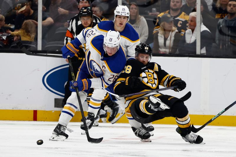 Oct 11, 2025; Boston, Massachusetts, USA; Buffalo Sabres defenseman Rasmus Dahlin (26) dumps Boston Bruins center Elias Lindholm (28) battling for the puck during the second period at TD Garden. Mandatory Credit: Winslow Townson-Imagn Images