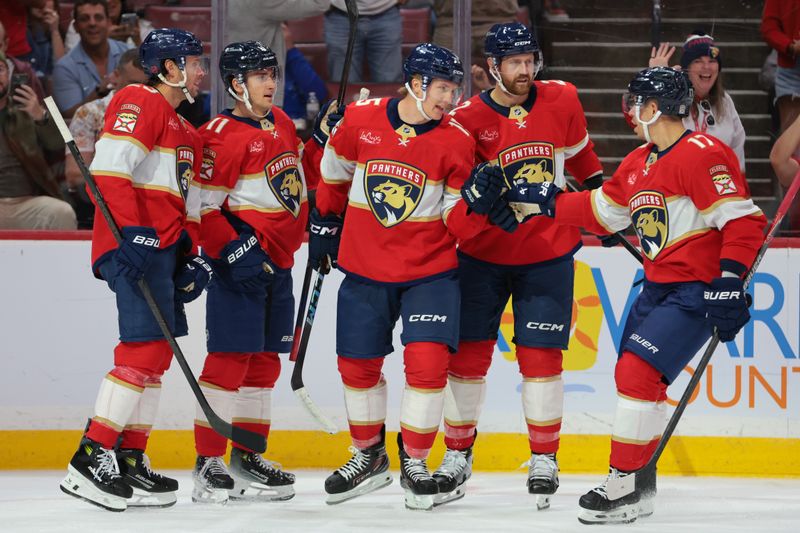 Oct 9, 2025; Sunrise, Florida, USA; Florida Panthers center Anton Lundell (15) celebrates with center Evan Rodrigues (17) after scoring against the Philadelphia Flyers during the second period at Amerant Bank Arena. Mandatory Credit: Sam Navarro-Imagn Images