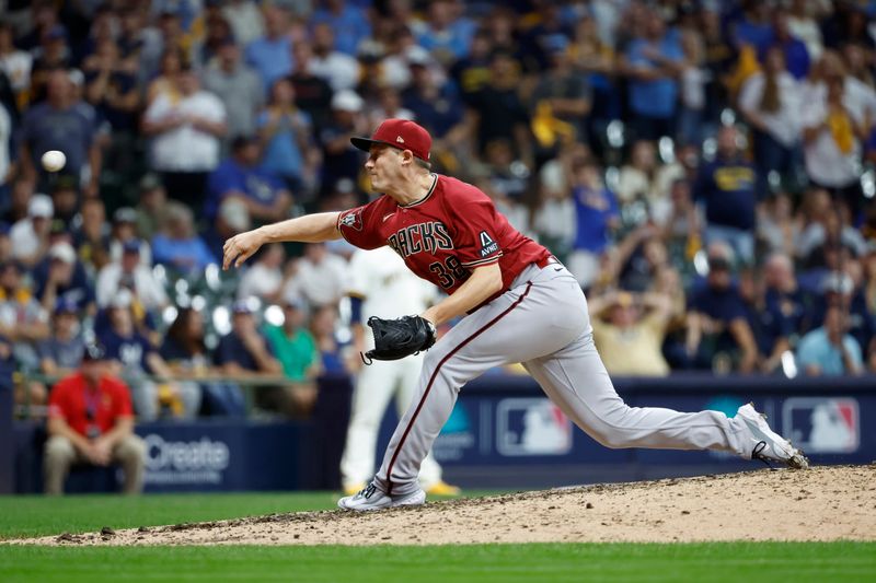 Oct 4, 2023; Milwaukee, Wisconsin, USA; Arizona Diamondbacks relief pitcher Paul Sewald (38) pitches against the Milwaukee Brewers in the ninth inning during game two of the Wildcard series for the 2023 MLB playoffs at American Family Field. Mandatory Credit: Kamil Krzaczynski-USA TODAY Sports