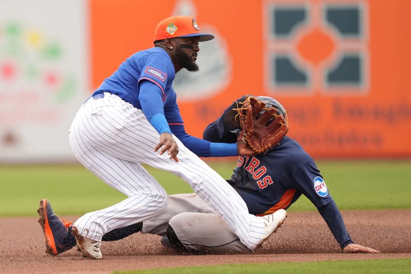 Mar 1, 2026; Port St. Lucie, Florida, USA;  Houston Astros left fielder Jose Altuve (27) steals second base as New York Mets second baseman Vidal Bruján (2) hits Altuve in the face with his glove in the first inning at Clover Park. Mandatory Credit: Jim Rassol-Imagn Images
