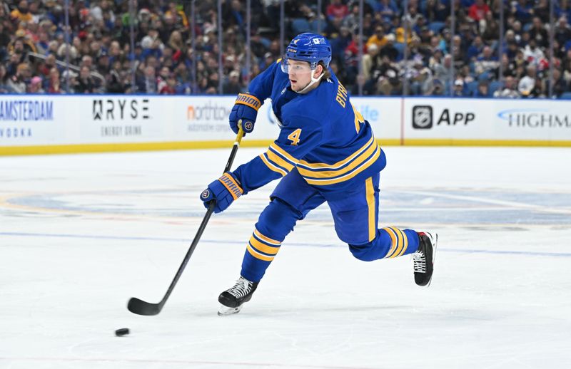 Nov 11, 2024; Buffalo, New York, USA; Buffalo Sabres defenseman Bowen Byram (4) shoots the puck in the second period against the Montreal Canadiens at KeyBank Center. Mandatory Credit: Mark Konezny-Imagn Images