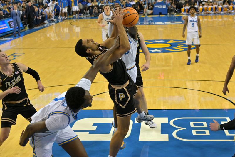 Jan 20, 2026; Los Angeles, California, USA;  Purdue Boilermakers forward Trey Kaufman-Renn (4), UCLA Bruins forward Xavier Booker (1) and guard Eric Dailey Jr. (3) battle for a rebound in the first half at Pauley Pavilion presented by Wescom Financial. Mandatory Credit: Jayne Kamin-Oncea-Imagn Images