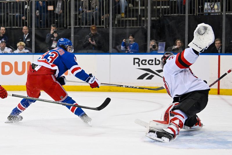 Dec 2, 2024; New York, New York, USA;  New Jersey Devils goaltender Jacob Markstrom (25) makes a save against New York Rangers center Mika Zibanejad (93) during the second period at Madison Square Garden. Mandatory Credit: Dennis Schneidler-Imagn Images