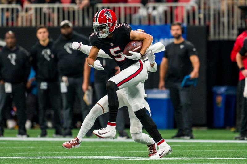 Atlanta Falcons wide receiver Drake London (5) catches a pass during the first half of an NFL football game against the Washington Commanders, Sunday, Oct. 15, 2023, in Atlanta. The Washington Commanders won 24-16. (AP Photo/Danny Karnik)