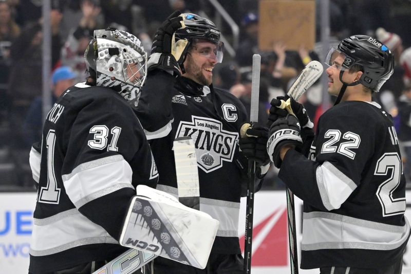 Nov 16, 2024; Los Angeles, California, USA; Los Angeles Kings goaltender David Rittich (31) is congratulated by center Anze Kopitar (11) and left wing Kevin Fiala (22) after defeating the Detroit Red Wings at Crypto.com Arena. Mandatory Credit: Jayne Kamin-Oncea-Imagn Images