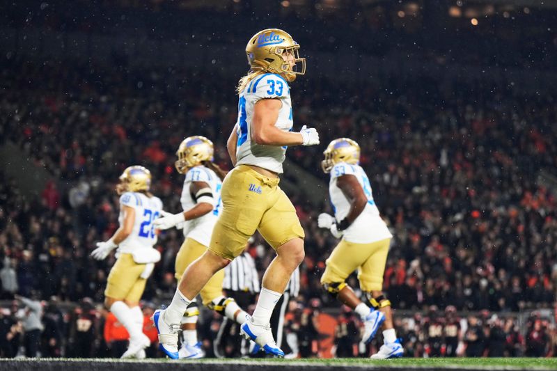 Oct 14, 2023; Corvallis, Oregon, USA; UCLA Bruins running back Carson Steele (33) celebrates after scoring a touchdown during the second half against the Oregon State Beavers at Reser Stadium. Mandatory Credit: Soobum Im-USA TODAY Sports