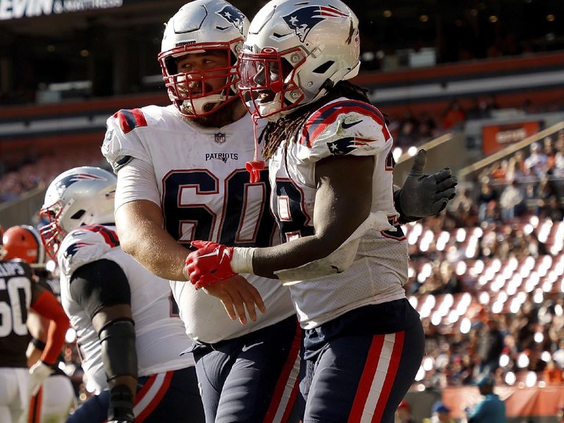 New England Patriots center David Andrews (60) congratulates running back Rhamondre Stevenson (38) after scoring a touchdown during an NFL football game against the Cleveland Browns, Sunday, Oct. 16, 2022, in Cleveland. (AP Photo/Kirk Irwin)