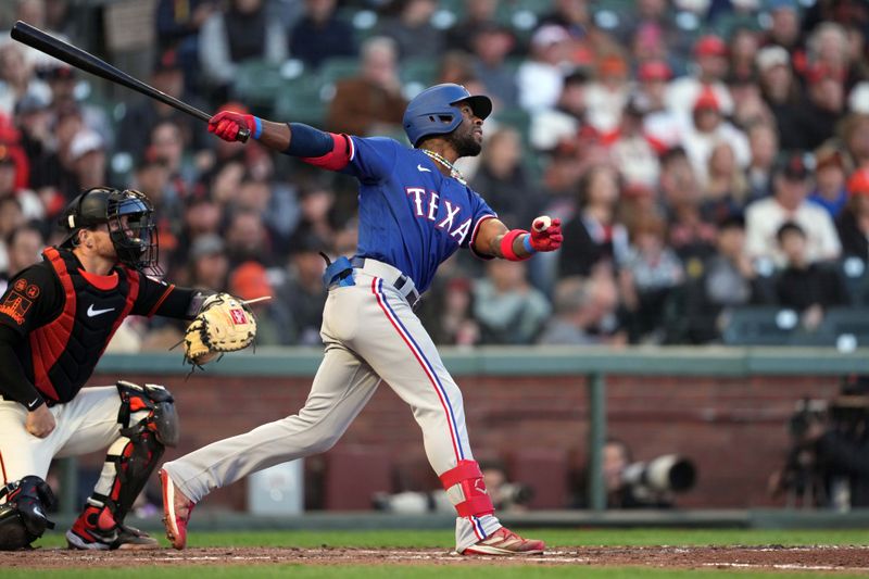 Aug 12, 2023; San Francisco, California, USA; Texas Rangers left fielder J.P. Martinez (50) hits an RBI sacrifice fly against the San Francisco Giants during the fifth inning at Oracle Park. Mandatory Credit: Darren Yamashita-USA TODAY Sports