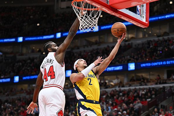 CHICAGO, ILLINOIS - DECEMBER 28:  Andrew Nembhard #2 of the Indiana Pacers scores on a lay up past Patrick Williams #44 of the Chicago Bulls in the first half on December 28, 2023 at the United Center in Chicago, Illinois.   NOTE TO USER: User expressly acknowledges and agrees that, by downloading and or using this photograph, User is consenting to the terms and conditions of the Getty Images License Agreement.  (Photo by Jamie Sabau/Getty Images)