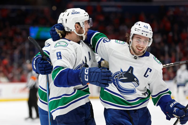 Feb 11, 2024; Washington, District of Columbia, USA; Vancouver Canucks center J.T. Miller (9) celebrates with Canucks defenseman Quinn Hughes (43) after scoring the game winning goal against the Washington Capitals at Capital One Arena. Mandatory Credit: Geoff Burke-USA TODAY Sports