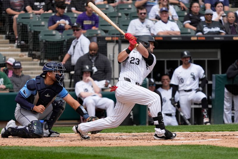 Apr 28, 2024; Chicago, Illinois, USA; Chicago White Sox outfielder Andrew Benintendi (23) hits a single against the Tampa Bay Rays at Guaranteed Rate Field. Mandatory Credit: David Banks-USA TODAY Sports