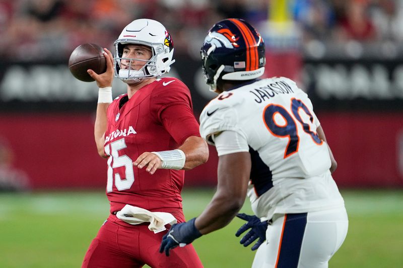 Arizona Cardinals quarterback Clayton Tune (15) passes against Denver Broncos defensive tackle Jordan Jackson (90) during the second half of an NFL preseason football game in Glendale, Ariz., Friday, Aug. 11, 2023. (AP Photo/Matt York)