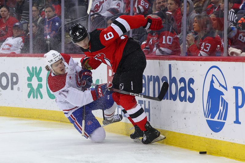 Jan 17, 2024; Newark, New Jersey, USA; Montreal Canadiens center Jake Evans (71) and New Jersey Devils defenseman John Marino (6) battle for the puck during the third period at Prudential Center. Mandatory Credit: Ed Mulholland-USA TODAY Sports