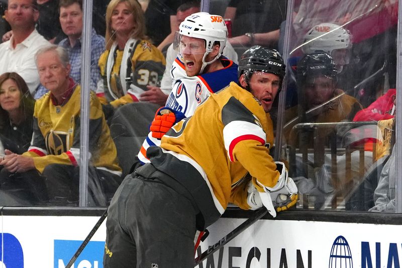 May 6, 2025; Las Vegas, Nevada, USA; Vegas Golden Knights defenseman Brayden McNabb (3) checks Edmonton Oilers center Connor McDavid (97) during the first period of game one of the second round of the 2025 Stanley Cup Playoffs at T-Mobile Arena. Mandatory Credit: Stephen R. Sylvanie-Imagn Images