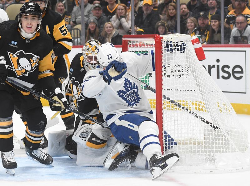 Nov 25, 2023; Pittsburgh, Pennsylvania, USA; Pittsburgh Penguins goalie Tristan Jarry (35) avoids a collision with Toronto Maple Leafs left wingMatthew Knmies (23) during the second period at PPG Paints Arena. Mandatory Credit: Philip G. Pavely-USA TODAY Sports