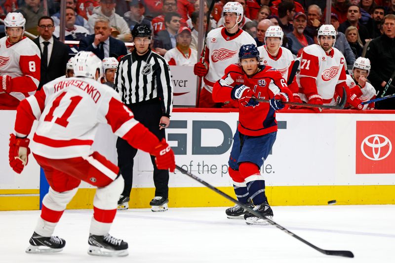 Mar 18, 2025; Washington, District of Columbia, USA; Washington Capitals defenseman Jakob Chychrun (6) passes the puck against Detroit Red Wings right wing Vladimir Tarasenko (11) during the third period at Capital One Arena. Mandatory Credit: Peter Casey-Imagn Images