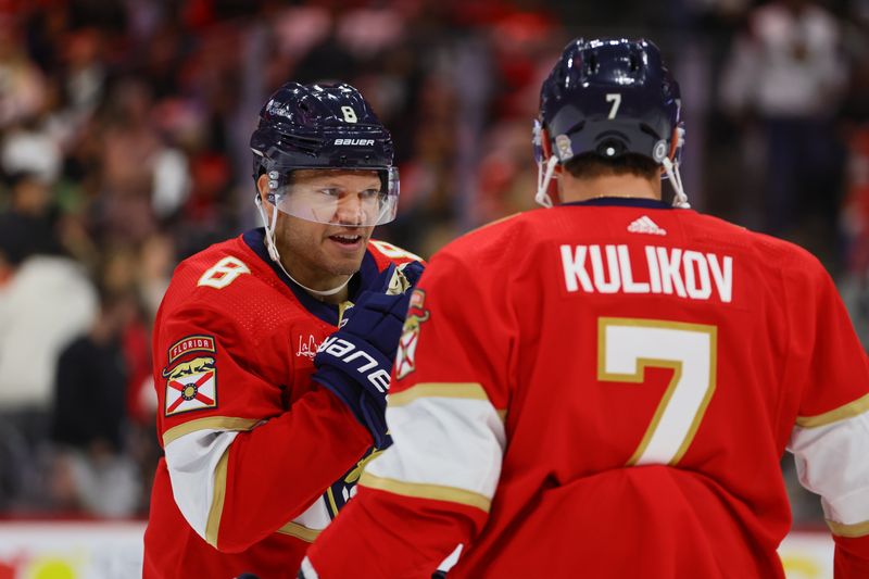 Apr 11, 2024; Sunrise, Florida, USA; Florida Panthers right wing Kyle Okposo (8) talks to defenseman Dmitry Kulikov (7) during the second period at Amerant Bank Arena. Mandatory Credit: Sam Navarro-USA TODAY Sports