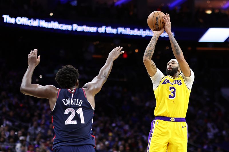 PHILADELPHIA, PENNSYLVANIA - NOVEMBER 27: Anthony Davis #3 of the Los Angeles Lakers shoots over Joel Embiid #21 of the Philadelphia 76ers during the third quarter at the Wells Fargo Center on November 27, 2023 in Philadelphia, Pennsylvania. NOTE TO USER: User expressly acknowledges and agrees that, by downloading and or using this photograph, User is consenting to the terms and conditions of the Getty Images License Agreement. (Photo by Tim Nwachukwu/Getty Images)