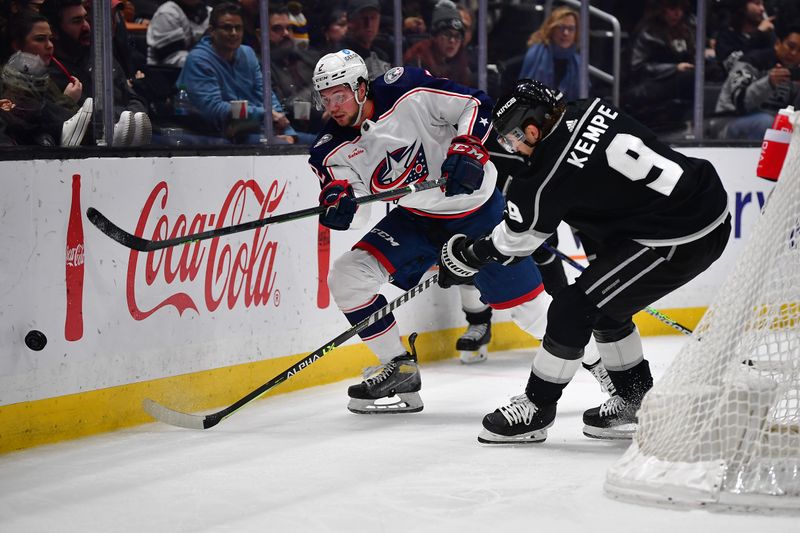 Mar 16, 2023; Los Angeles, California, USA; Columbus Blue Jackets defenseman Andrew Peeke (2) moves the puck against Los Angeles Kings right wing Adrian Kempe (9) during the second period at Crypto.com Arena. Mandatory Credit: Gary A. Vasquez-USA TODAY Sports