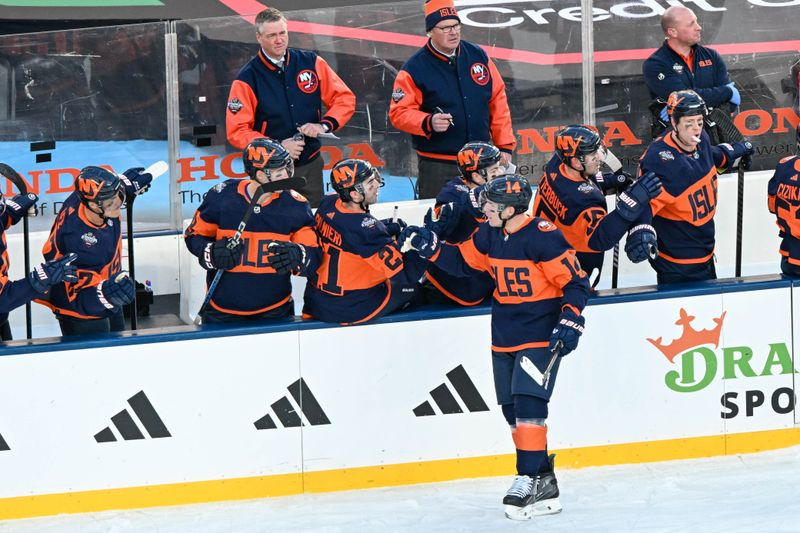 Feb 18, 2024; East Rutherford, New Jersey, USA;  New York Islanders center Bo Horvat (14) celebrates his goal against the New York Rangers during the first period in a Stadium Series ice hockey game at MetLife Stadium. Mandatory Credit: Dennis Schneidler-USA TODAY Sports