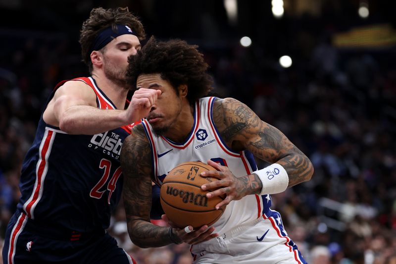 WASHINGTON, DC - FEBRUARY 10: Kelly Oubre Jr. #9 of the Philadelphia 76ers dribbles past Corey Kispert #24 of the Washington Wizards during the second half at Capital One Arena on February 10, 2024 in Washington, DC. NOTE TO USER: User expressly acknowledges and agrees that, by downloading and or using this photograph, User is consenting to the terms and conditions of the Getty Images License Agreement.  (Photo by Patrick Smith/Getty Images)