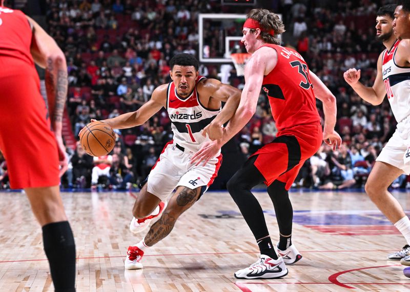 MONTREAL, CANADA - OCTOBER 06: Johnny Davis #1 of the Washington Wizards dribbles the ball against Branden Carlson #35 of the Toronto Raptors during the second half of a preseason NBA game at the Bell Centre on October 6, 2024 in Montreal, Quebec, Canada. The Toronto Raptors defeated the Washington Wizards 125-98. NOTE TO USER: User expressly acknowledges and agrees that, by downloading and or using this photograph, User is consenting to the terms and conditions of the Getty Images License Agreement. (Photo by Minas Panagiotakis/Getty Images)