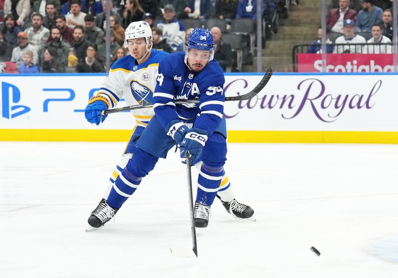 Mar 6, 2024; Toronto, Ontario, CAN; Toronto Maple Leafs center Auston Matthews (34) battles for the puck with Buffalo Sabres defenseman Jacob Bryson (78) during the first period at Scotiabank Arena. Mandatory Credit: Nick Turchiaro-USA TODAY Sports