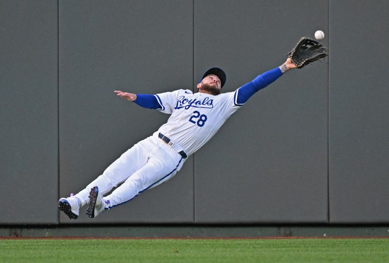 May 21, 2024; Kansas City, Missouri, USA;  Kansas City Royals center fielder Kyle Isbel (28) can't make the catch from a triple hit by Detroit Tigers Matt Vierling (8) in the fourth inning at Kauffman Stadium. Mandatory Credit: Peter Aiken-USA TODAY Sports