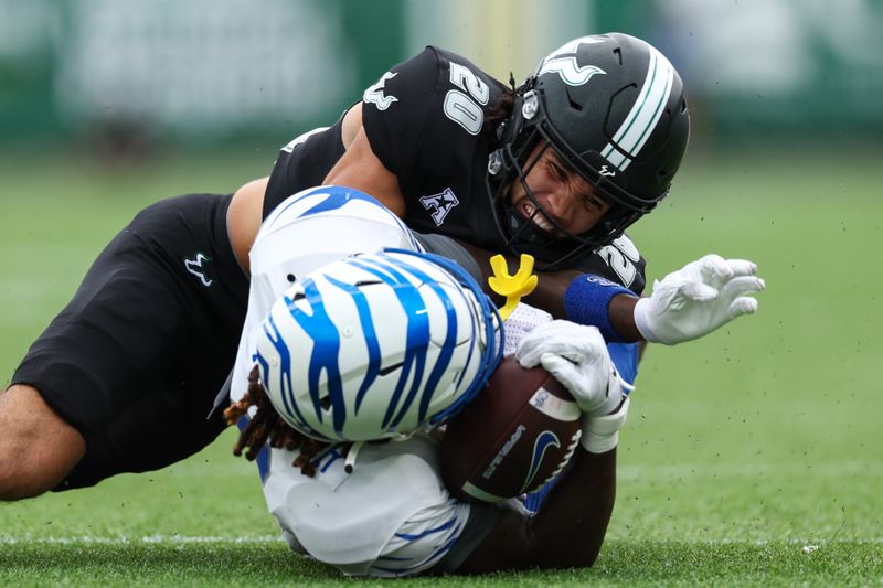 Oct 12, 2024; Orlando, Florida, USA; Memphis Tigers wide receiver Roc Taylor (3) catches a pass defended by South Florida Bulls cornerback Brent Austin (20) in the first quarter  at Camping World Stadium. Mandatory Credit: Nathan Ray Seebeck-Imagn Images