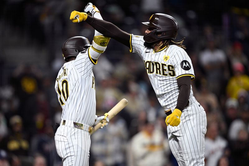 Jun 10, 2024; San Diego, California, USA; San Diego Padres right fielder Fernando Tatis Jr. (right) is congratulated by left fielder Jurickson Profar (10) after hitting a home run against the Oakland Athletics during the fifth inning at Petco Park. Mandatory Credit: Orlando Ramirez-USA TODAY Sports