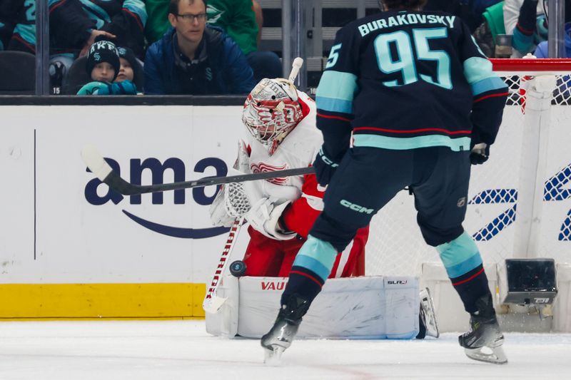 Feb 19, 2024; Seattle, Washington, USA; Detroit Red Wings goaltender Alex Lyon (34) blocks a shot against the Seattle Kraken during the first period at Climate Pledge Arena. Mandatory Credit: Joe Nicholson-USA TODAY Sports