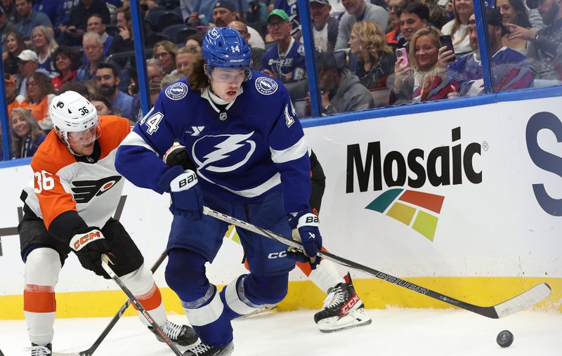 Nov 7, 2024; Tampa, Florida, USA; Tampa Bay Lightning center Conor Geekie (14) skates with the puck as Philadelphia Flyers defenseman Emil Andrae (36) defends during the first period at Amalie Arena. Mandatory Credit: Kim Klement Neitzel-Imagn Images