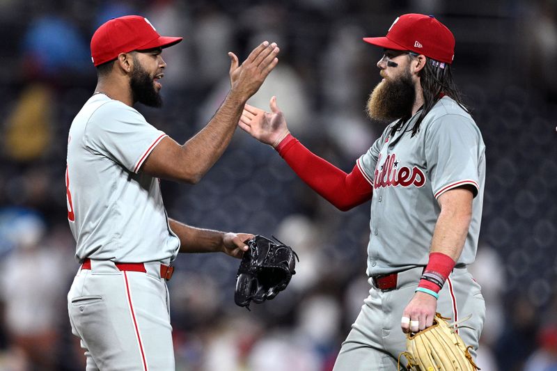 Apr 26, 2024; San Diego, California, USA; Philadelphia Phillies relief pitcher Seranthony Dominguez (58) celebrates on the field with Philadelphia Phillies left fielder Brandon Marsh (16) after defeating the San Diego Padres at Petco Park. Mandatory Credit: Orlando Ramirez-USA TODAY Sports