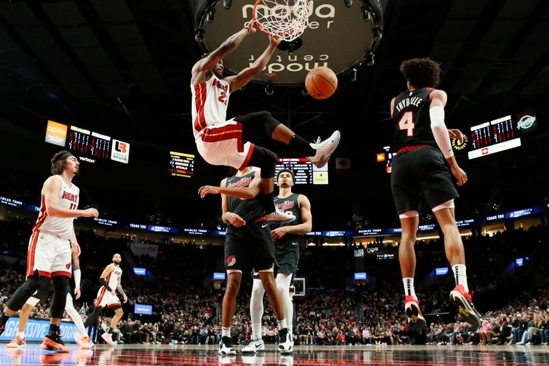 PORTLAND, OREGON - FEBRUARY 27: Jimmy Butler #22 of the Miami Heat dunks the ball as Kris Murray #8, Toumani Camara #33 , and Matisse Thybulle #4 of the Portland Trail Blazers look on during the second half at Moda Center on February 27, 2024 in Portland, Oregon. NOTE TO USER: User expressly acknowledges and agrees that, by downloading and or using this photograph, User is consenting to the terms and conditions of the Getty Images License Agreement. (Photo by Soobum Im/Getty Images)