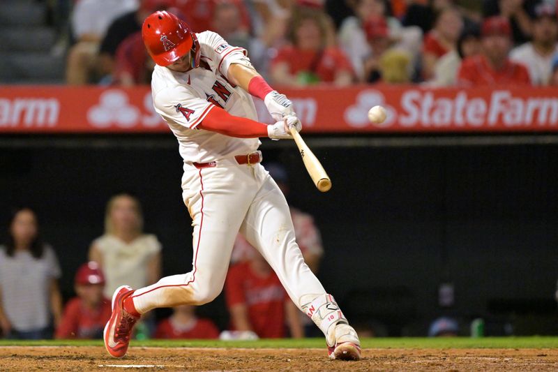 Jun 28, 2025; Anaheim, California, USA;  Los Angeles Angels third baseman Kevin Newman (10) hits a three-run home run in the seventh inning against the Washington Nationals at Angel Stadium. Mandatory Credit: Jayne Kamin-Oncea-Imagn Images