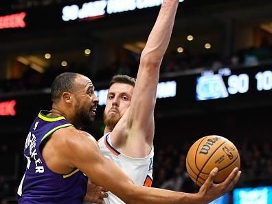 SALT LAKE CITY, UTAH - DECEMBER 13: Talen Horton-Tucker #5 of the Utah Jazz shoots over Isaiah Hartenstein #55 of the New York Knicks  during the second half of a game at Delta Center on December 13, 2023 in Salt Lake City, Utah. NOTE TO USER: User expressly acknowledges and agrees that, by downloading and or using this photograph, User is consenting to the terms and conditions of the Getty Images License Agreement. (Photo by Alex Goodlett/Getty Images)