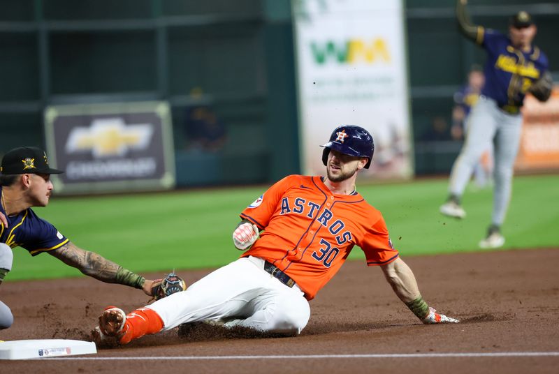 May 17, 2024; Houston, Texas, USA;  Houston Astros right fielder Kyle Tucker (30) is tagged out by Milwaukee Brewers second baseman Brice Turang (2) after he tried to stretch a double into a triple in the first inning at Minute Maid Park. Mandatory Credit: Thomas Shea-USA TODAY Sports