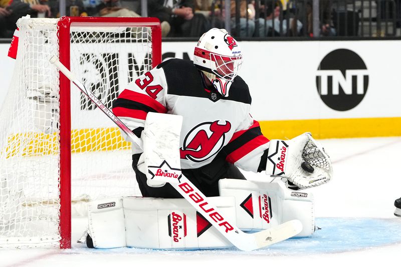 Mar 17, 2024; Las Vegas, Nevada, USA; New Jersey Devils goaltender Jake Allen (34) makes a save against the Vegas Golden Knights during the first period at T-Mobile Arena. Mandatory Credit: Stephen R. Sylvanie-USA TODAY Sports