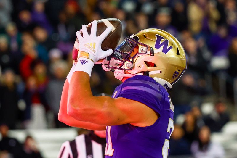 Nov 19, 2022; Seattle, Washington, USA; Washington Huskies running back Wayne Taulapapa (21) reacts after rushing for a touchdown against the Colorado Buffaloes during the first quarter at Alaska Airlines Field at Husky Stadium. Mandatory Credit: Joe Nicholson-USA TODAY Sports