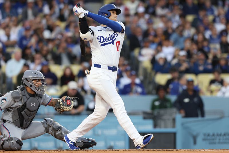 Apr 28, 2025; Los Angeles, California, USA; Los Angeles Dodgers two-way player Shohei Ohtani (17) hits a single in the first inning against the Miami Marlins during the first inning at Dodger Stadium. Mandatory Credit: Jason Parkhurst-Imagn Images