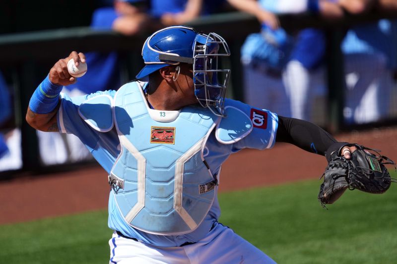 Mar 11, 2024; Surprise, Arizona, USA; Kansas City Royals catcher Salvador Perez (13) throws to second base against the San Francisco Giants during the second inning at Surprise Stadium. Mandatory Credit: Joe Camporeale-USA TODAY Sports