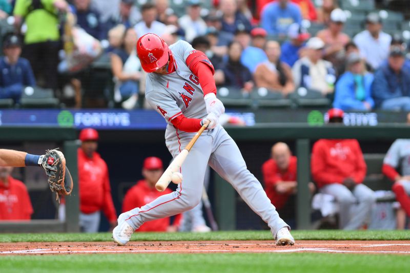 Jul 22, 2024; Seattle, Washington, USA; Los Angeles Angels left fielder Taylor Ward (3) hits a single against the Seattle Mariners during the first inning at T-Mobile Park. Mandatory Credit: Steven Bisig-USA TODAY Sports