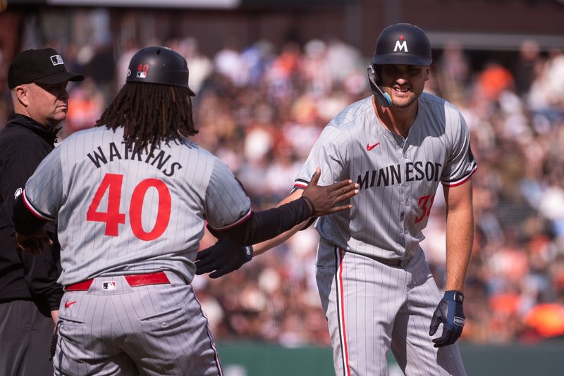 Jul 13, 2024; San Francisco, California, USA; Minnesota Twins outfielder Matt Wallner (38) celebrates with third base coach/outfield coach Tommy Watkins (40) after hitting a double against the San Francisco Giants during the fourth inning at Oracle Park. Mandatory Credit: Ed Szczepanski-USA TODAY Sports
