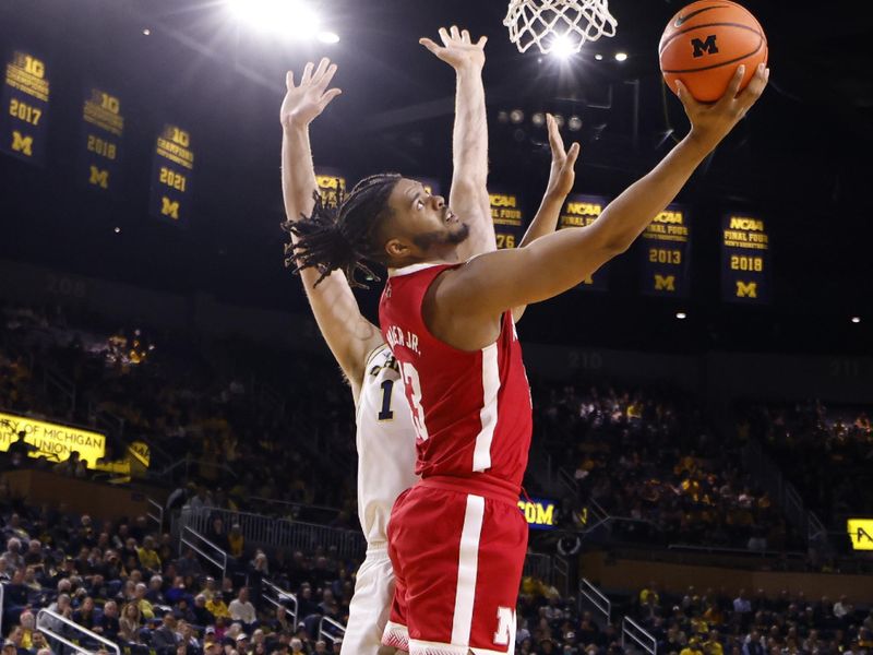 Feb 8, 2023; Ann Arbor, Michigan, USA;  Nebraska Cornhuskers forward Derrick Walker (13) shoots on Michigan Wolverines center Hunter Dickinson (1) in the second half at Crisler Center. Mandatory Credit: Rick Osentoski-USA TODAY Sports