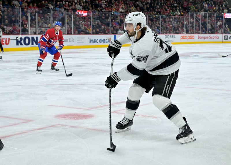 Oct 17, 2024; Montreal, Quebec, CAN; Los Angeles Kings forward Philllip Danault (24) shoots the puck during the third period of the game against the Montreal Canadiens at the Bell Centre. Mandatory Credit: Eric Bolte-Imagn Images